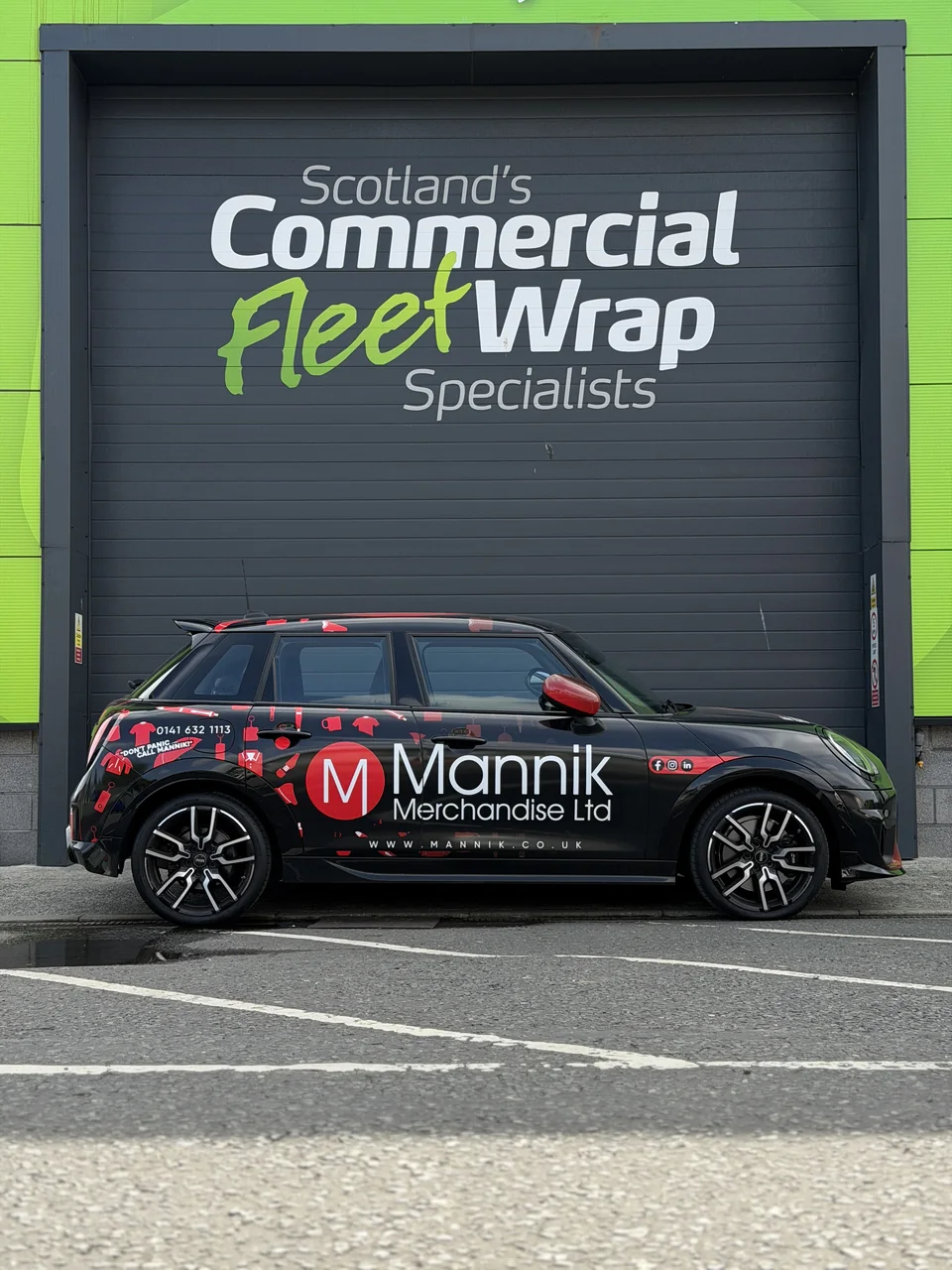 The black Mannik Mini with red branded graphics parked outside Scotland’s Commercial Fleet Wrap Specialists